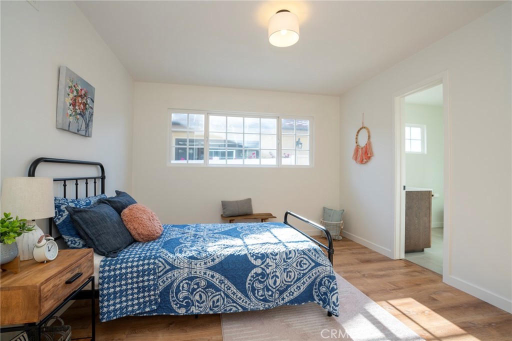 1718 West 27th Street San Pedro, CA 90732 - Photo 27 of 42 a bedroom with a bed and wooden floor