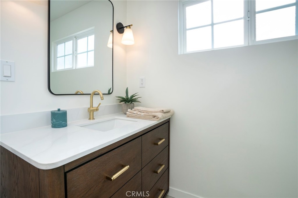 1718 West 27th Street San Pedro, CA 90732 - Photo 29 of 42 a bathroom with a sink vanity and a mirror