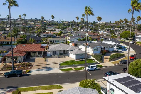 an aerial view of a house with a garden and a sitting area