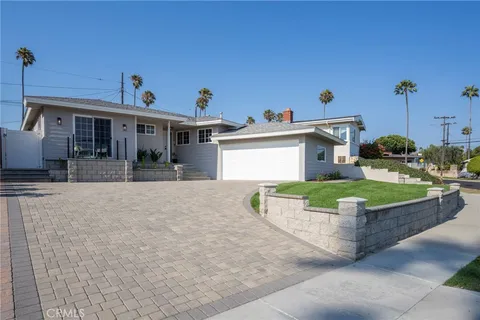 a view of a house with a yard and sitting area