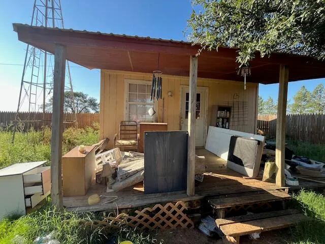 a view of a patio with table and chairs and potted plants