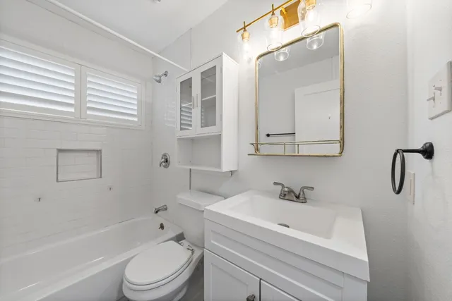 a bathroom with a sink a toilet and bathtub
