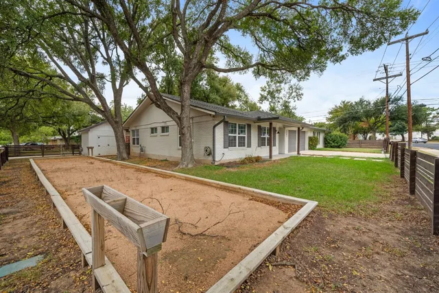 a view of house with yard outdoor seating