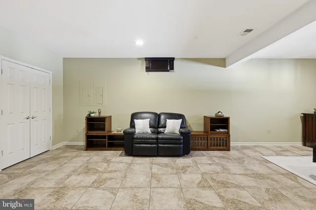 a view of a deck with couches table and chairs with wooden floor and fence