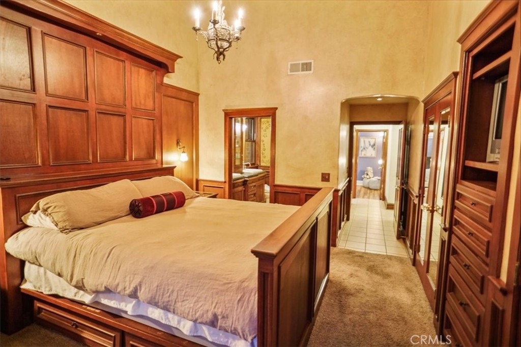 25326 Avenida Cappela Valencia, CA 91355 - Photo 12 of 48 a bedroom with a bed next to a large window