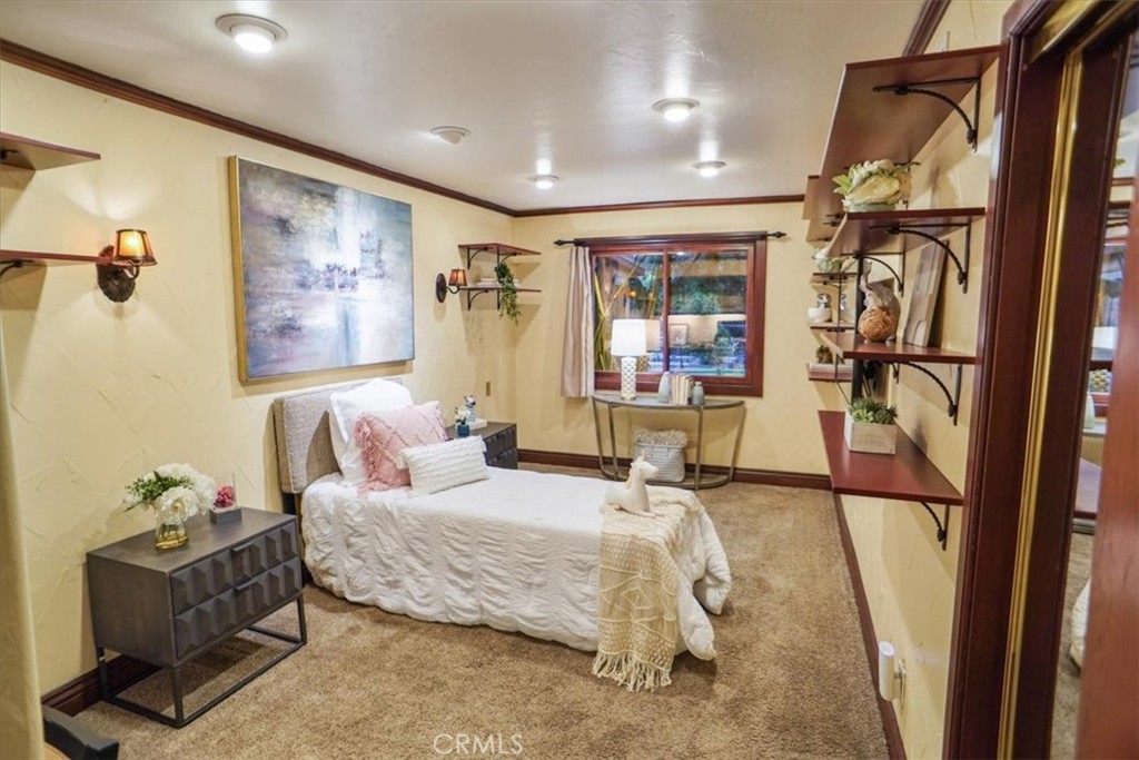 25326 Avenida Cappela Valencia, CA 91355 - Photo 16 of 48 a bedroom with a bed couch and window