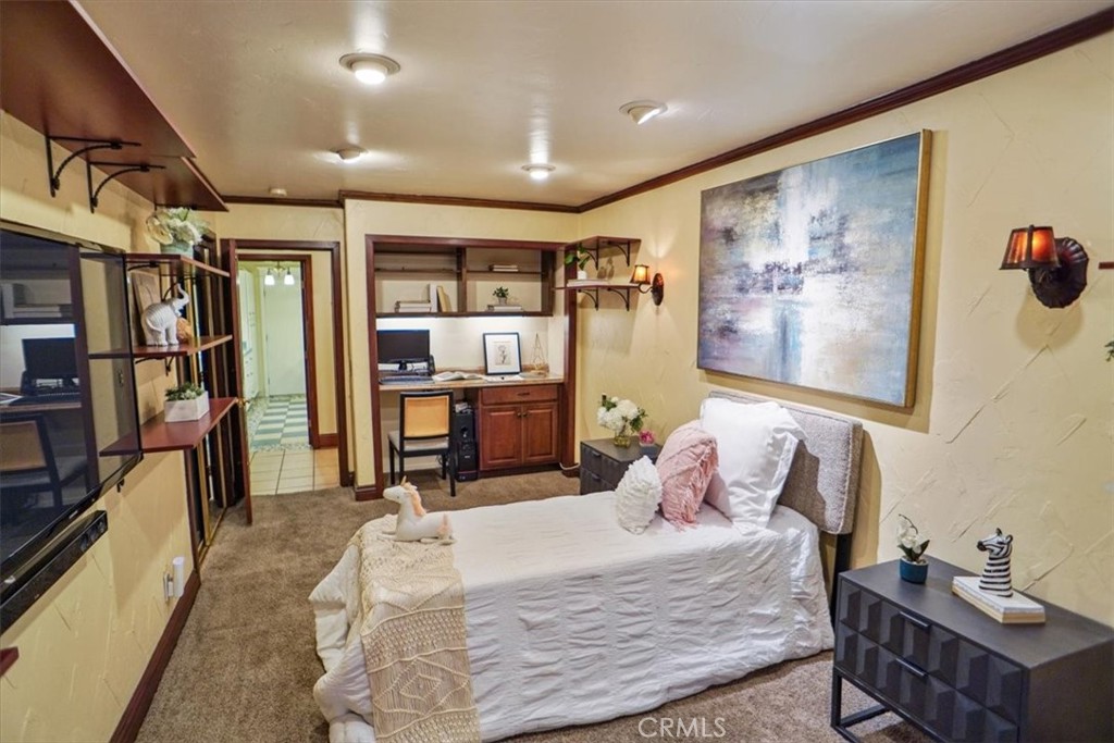 25326 Avenida Cappela Valencia, CA 91355 - Photo 17 of 48 a bedroom with a bed a large window and book self