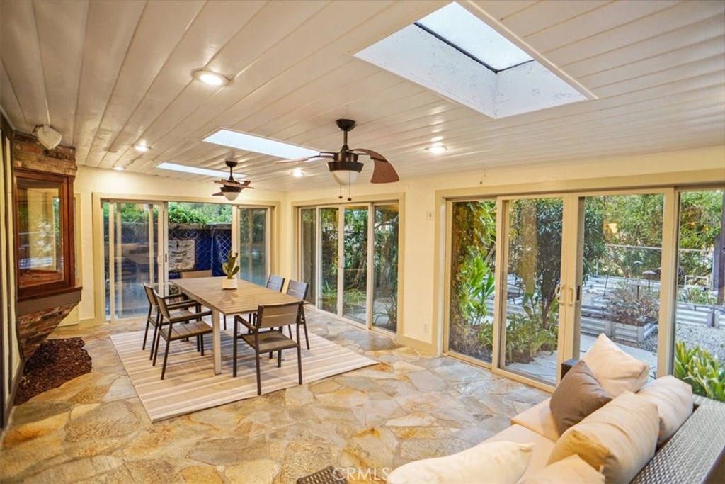 25326 Avenida Cappela Valencia, CA 91355 - Photo 27 of 48 a dining room with furniture and large windows