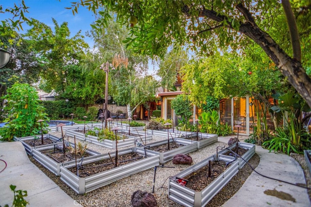 25326 Avenida Cappela Valencia, CA 91355 - Photo 29 of 48 a view of a backyard with couches chair and a table and chairs