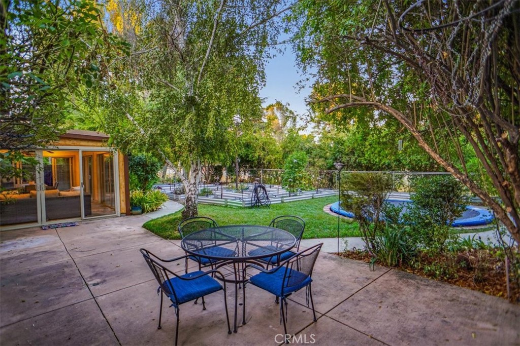 25326 Avenida Cappela Valencia, CA 91355 - Photo 31 of 48 a view of a chairs and table in backyard