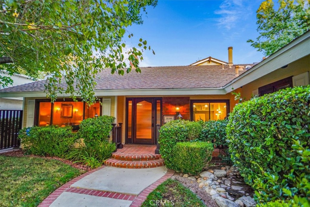 25326 Avenida Cappela Valencia, CA 91355 - Photo 2 of 48 a front view of a house with a yard