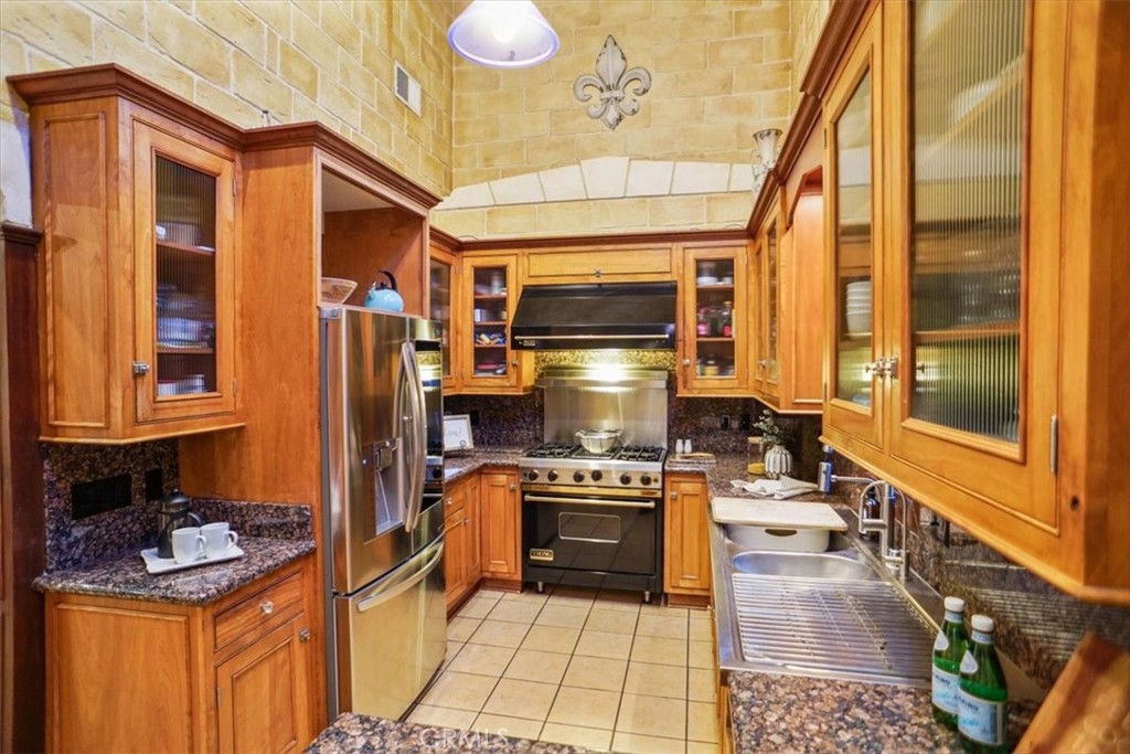 25326 Avenida Cappela Valencia, CA 91355 - Photo 7 of 48 a kitchen with a stove a refrigerator and a stove