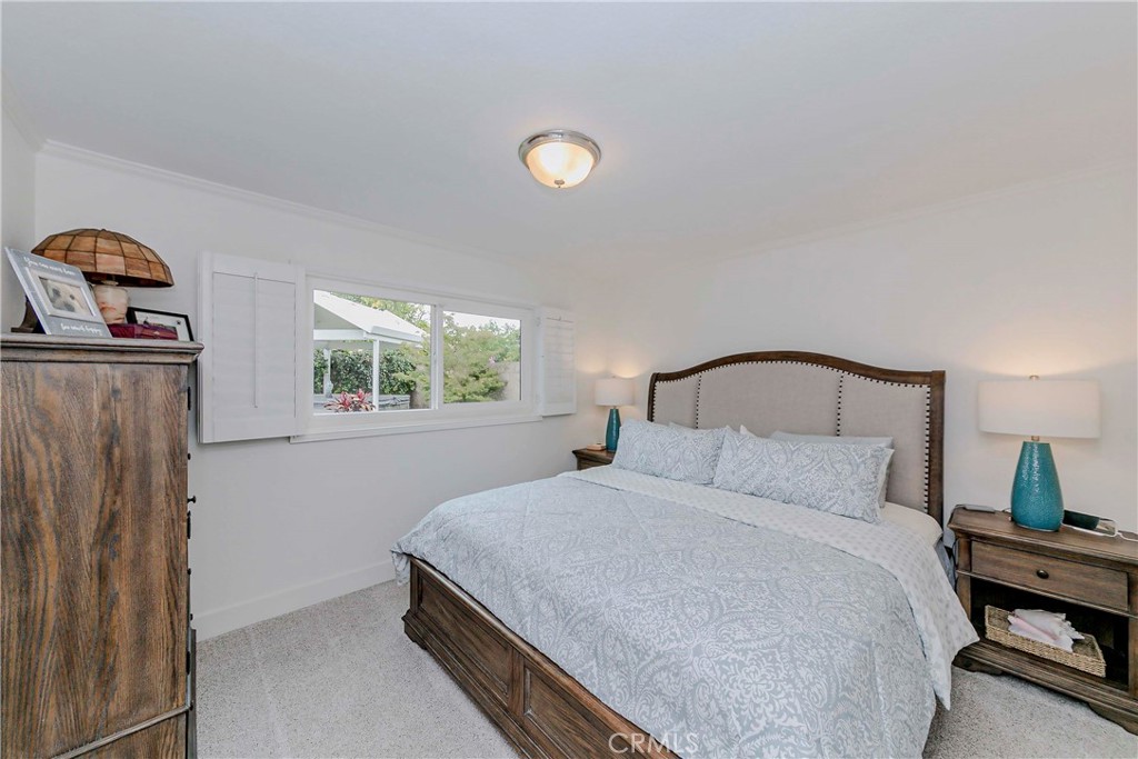10252 Lorraine Lane Cypress, CA 90630 - Photo 26 of 44 a bedroom with a bed and a window