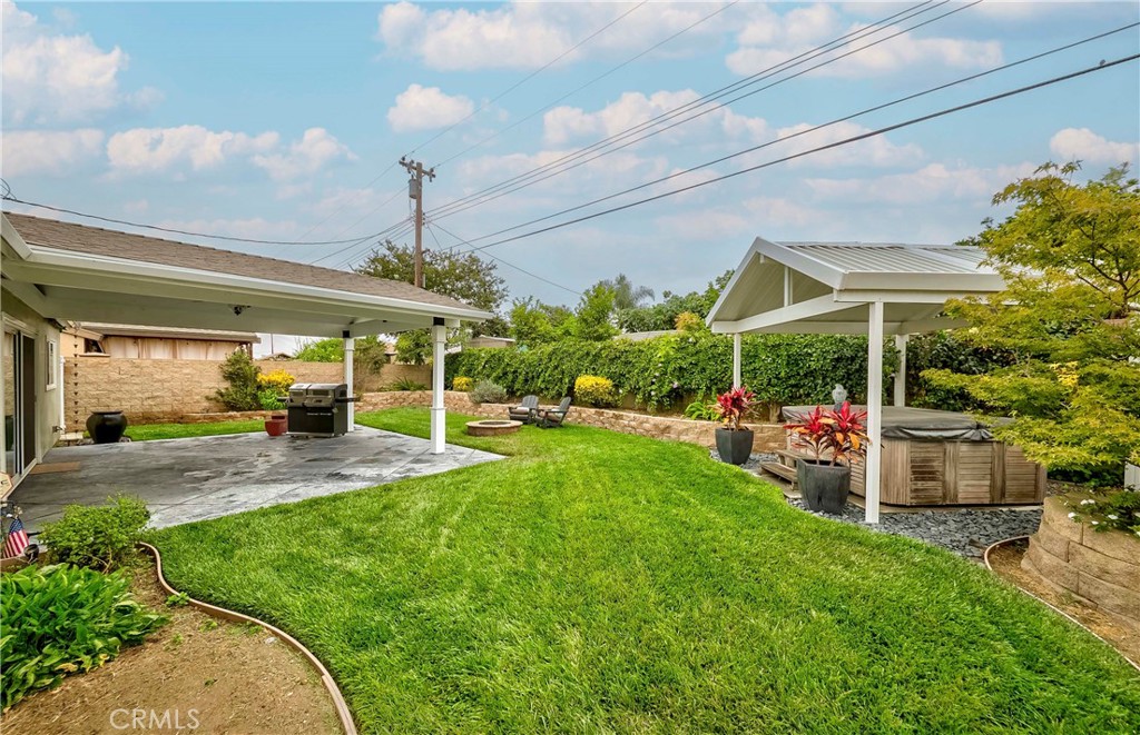 10252 Lorraine Lane Cypress, CA 90630 - Photo 35 of 44 a view of a patio with table and chairs potted plants