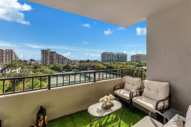 a balcony with a table and chairs