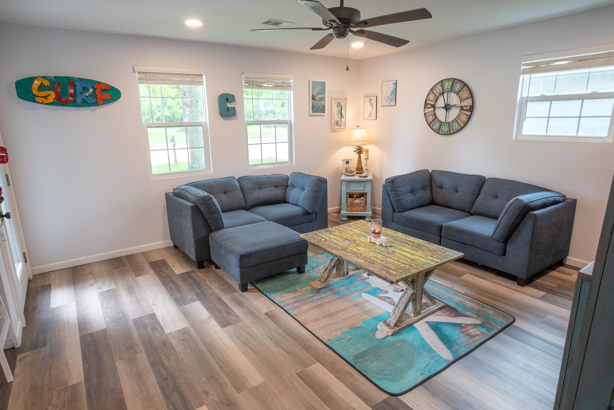 846 South Anderson Street Angleton, TX 77515 - Photo 6 of 30 This cozy living room features modern interior paint, The space is brightened by natural light from three windows, complemented by stylish ceiling fan. The laminate flooring adds warmth to this inviting space.