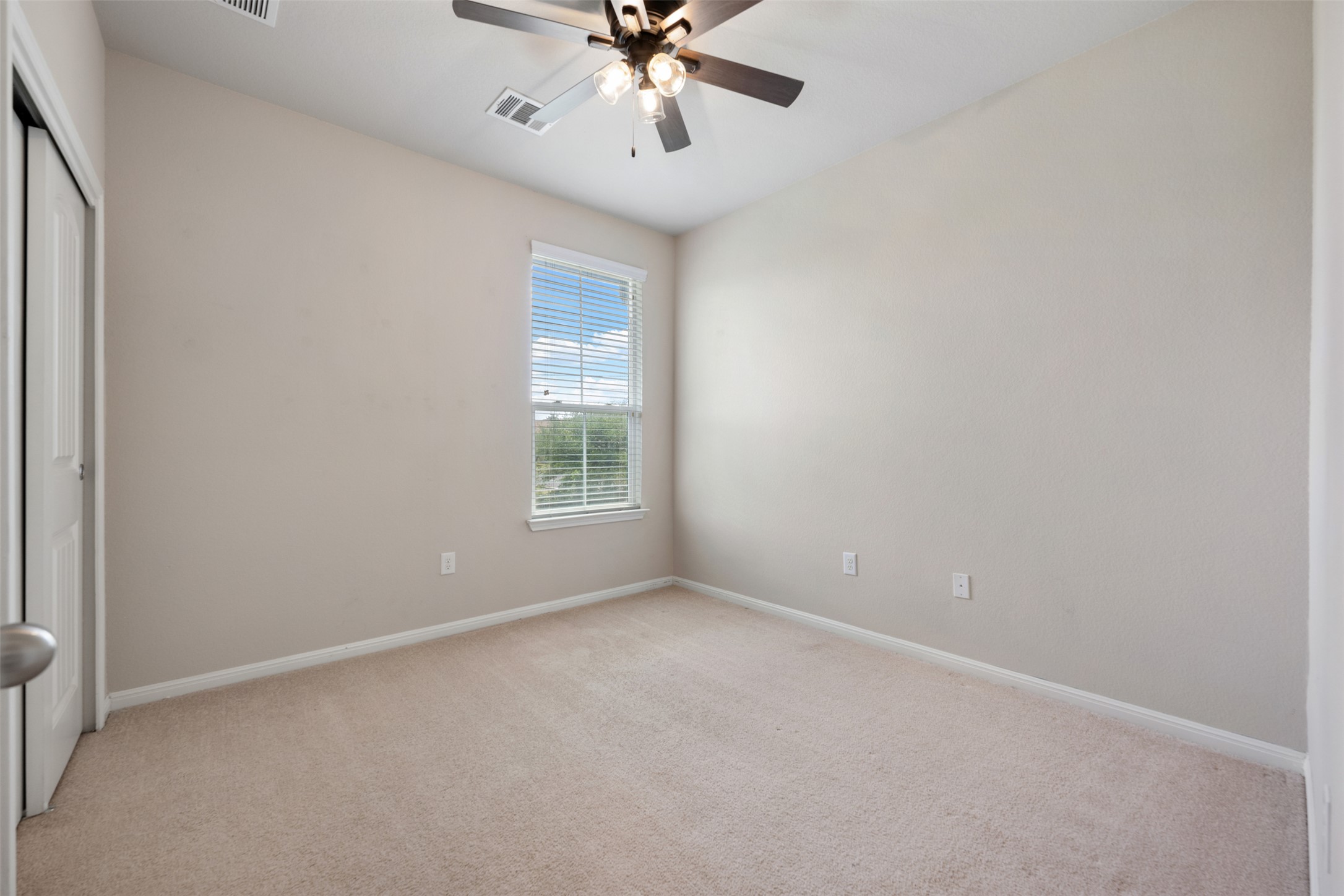 211 Parable Cove Pflugerville, TX 78660 - Photo 31 of 40 Carpeted room featuring a single window with horizontal blinds, a ceiling fan with integrated lighting, and neutral wall tones