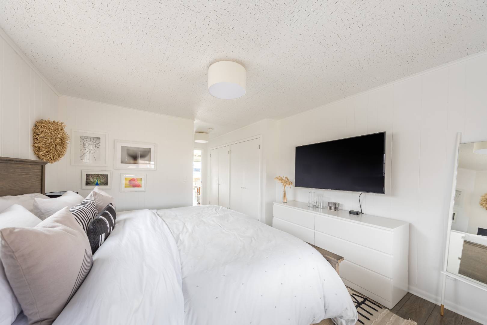 351 East Lake Drive Montauk, NY 11954 - Photo 15 of 30 a bedroom with a bed and a flat screen tv