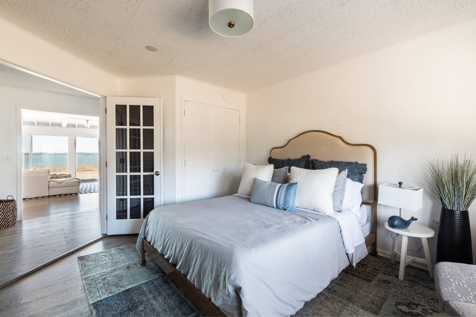 351 East Lake Drive Montauk, NY 11954 - Photo 18 of 30 a bedroom with a large bed and a book shelf