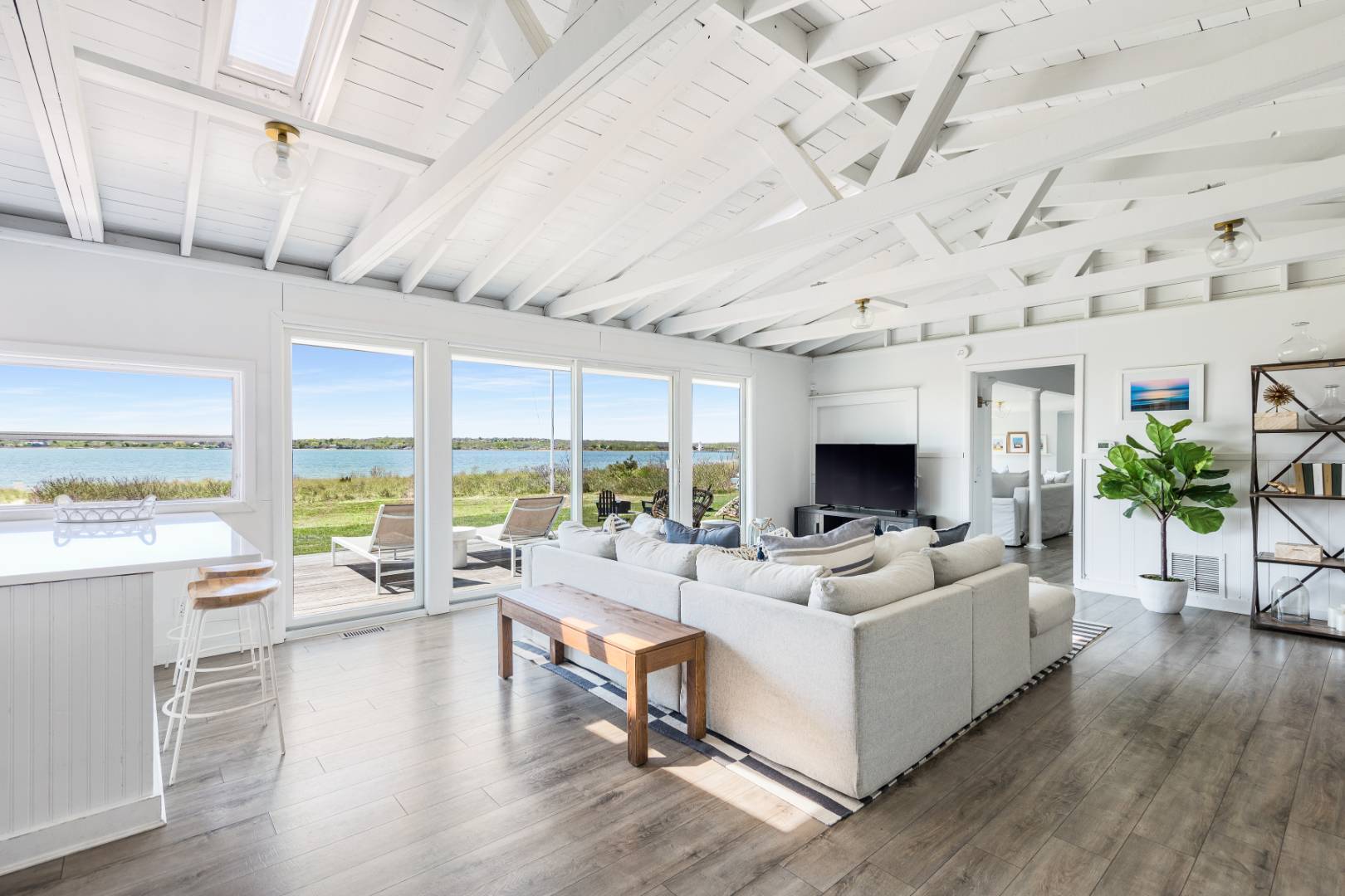 351 East Lake Drive Montauk, NY 11954 - Photo 6 of 30 a living room with furniture large windows and wooden floor