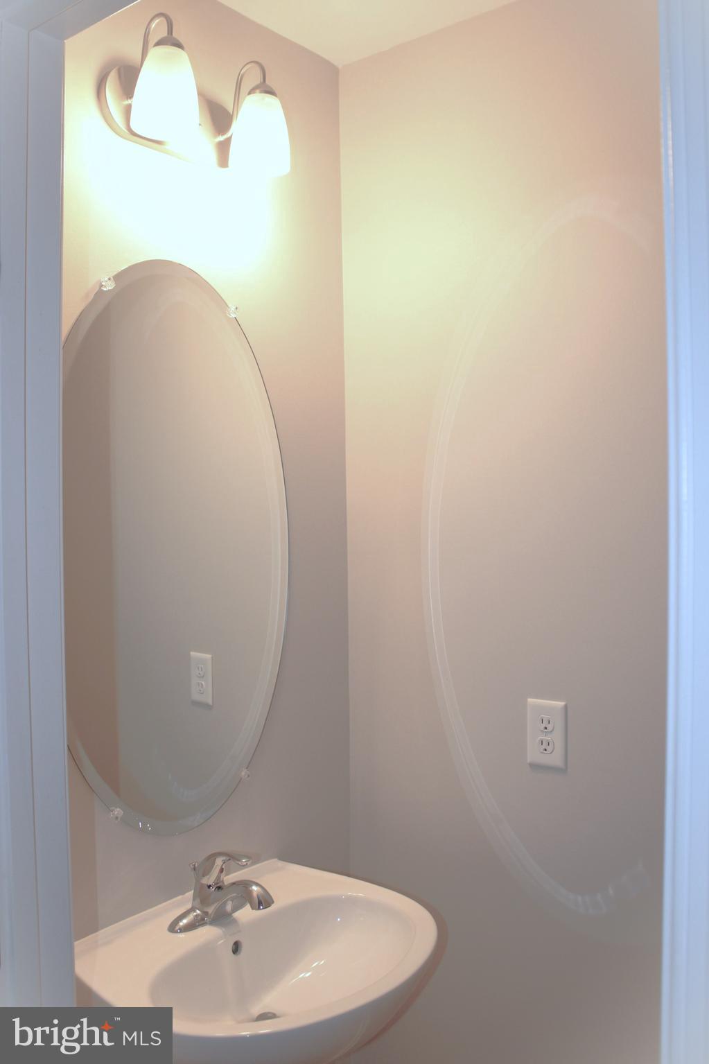 8 Cecily Way Ranson, WV 25438 - Photo 14 of 26 a bathroom with a sink and mirror