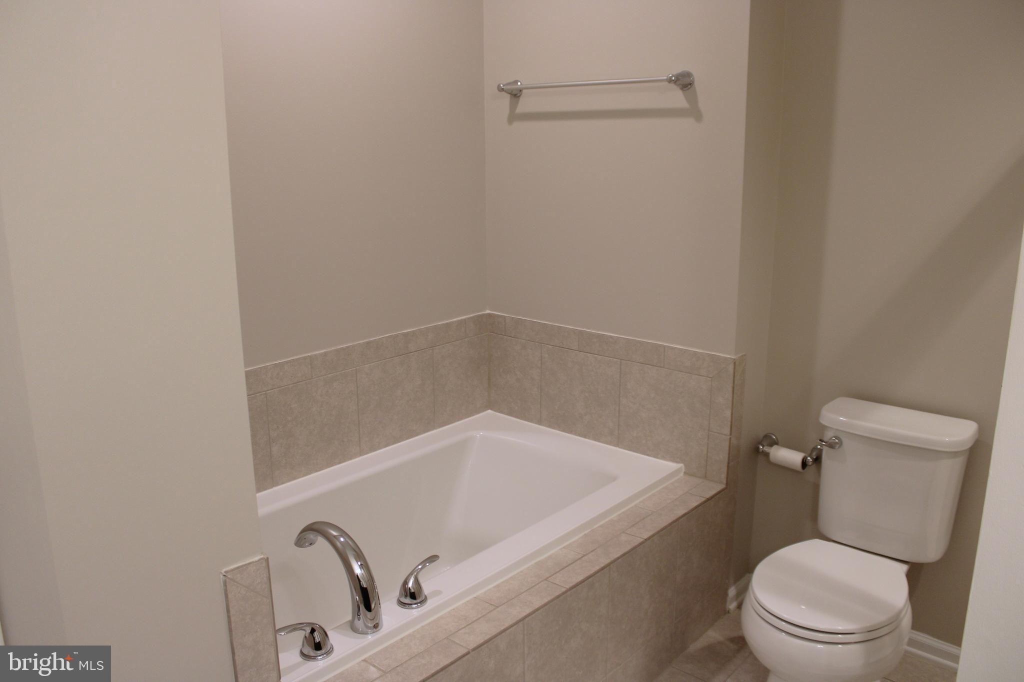 8 Cecily Way Ranson, WV 25438 - Photo 20 of 26 a white bath tub sitting next to a toilet