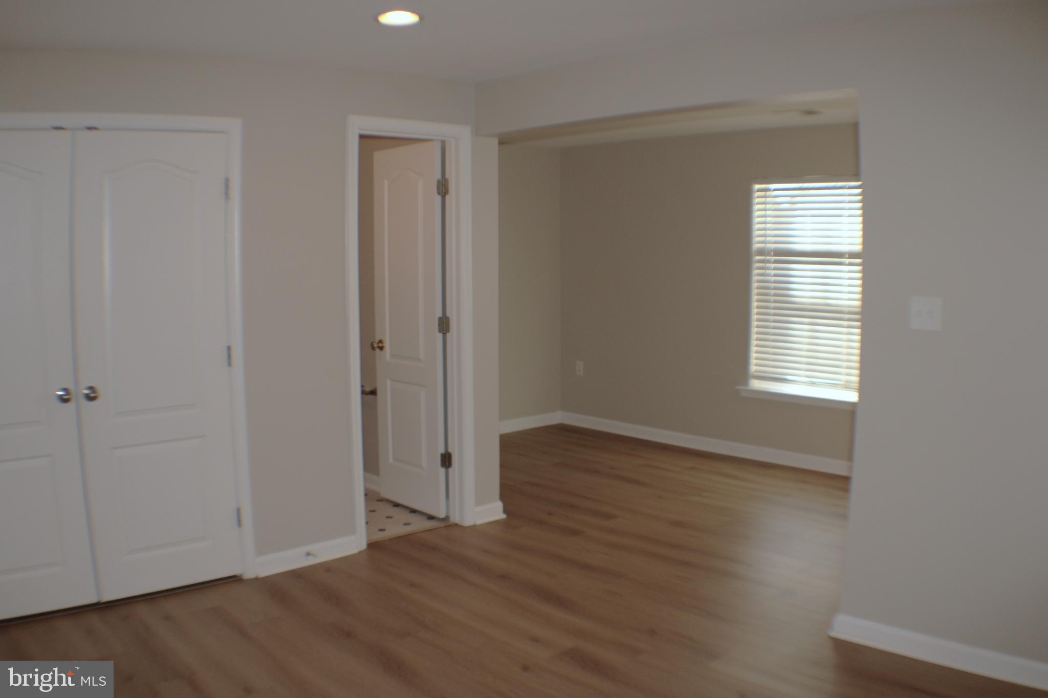 8 Cecily Way Ranson, WV 25438 - Photo 6 of 26 a view of an empty room with wooden floor and a window