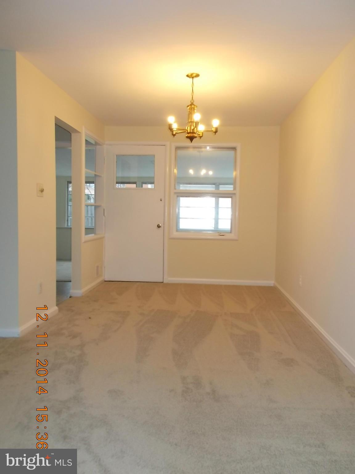 3505 May Street Silver Spring, MD 20906 - Photo 3 of 22 en empty room with windows and chandelier