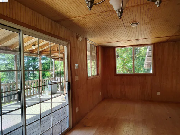 an empty room with windows and stairs