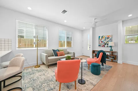 a living room with furniture and a potted plant