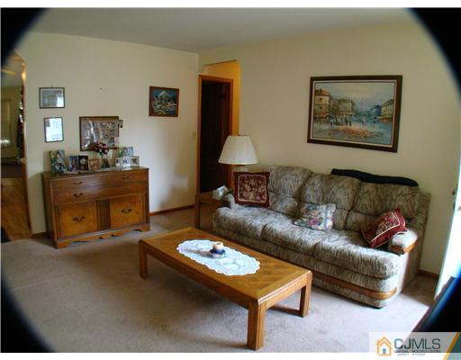 104 Idlewild Road Edison, NJ 08817 - Photo 3 of 13 a living room with furniture and a table