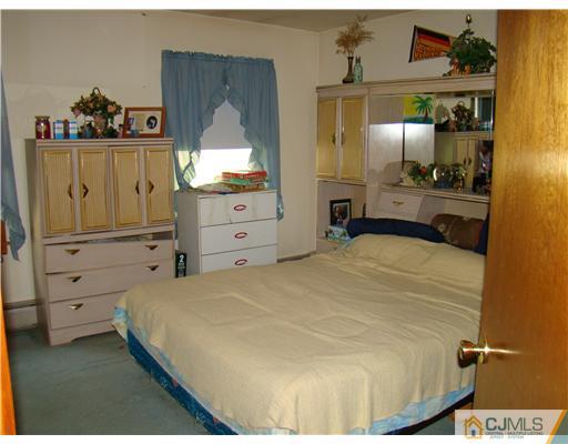 104 Idlewild Road Edison, NJ 08817 - Photo 8 of 13 a bedroom with a bed and a dresser