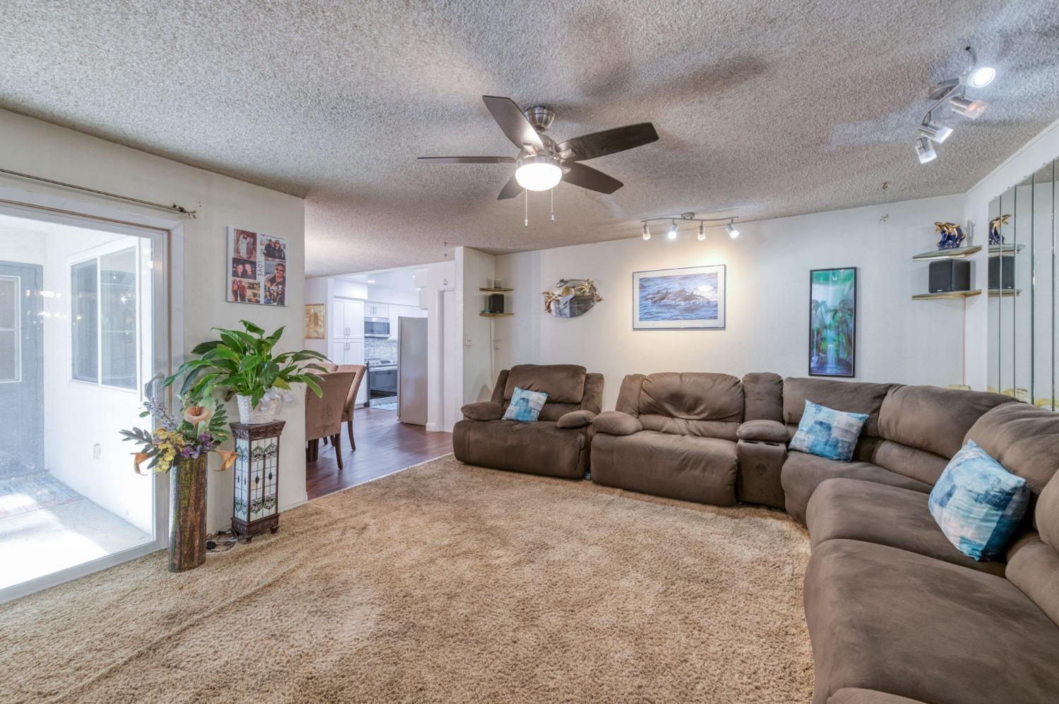 6811 North Backer Avenue Fresno, CA 93710 - Photo 12 of 26 a living room with furniture and a chandelier