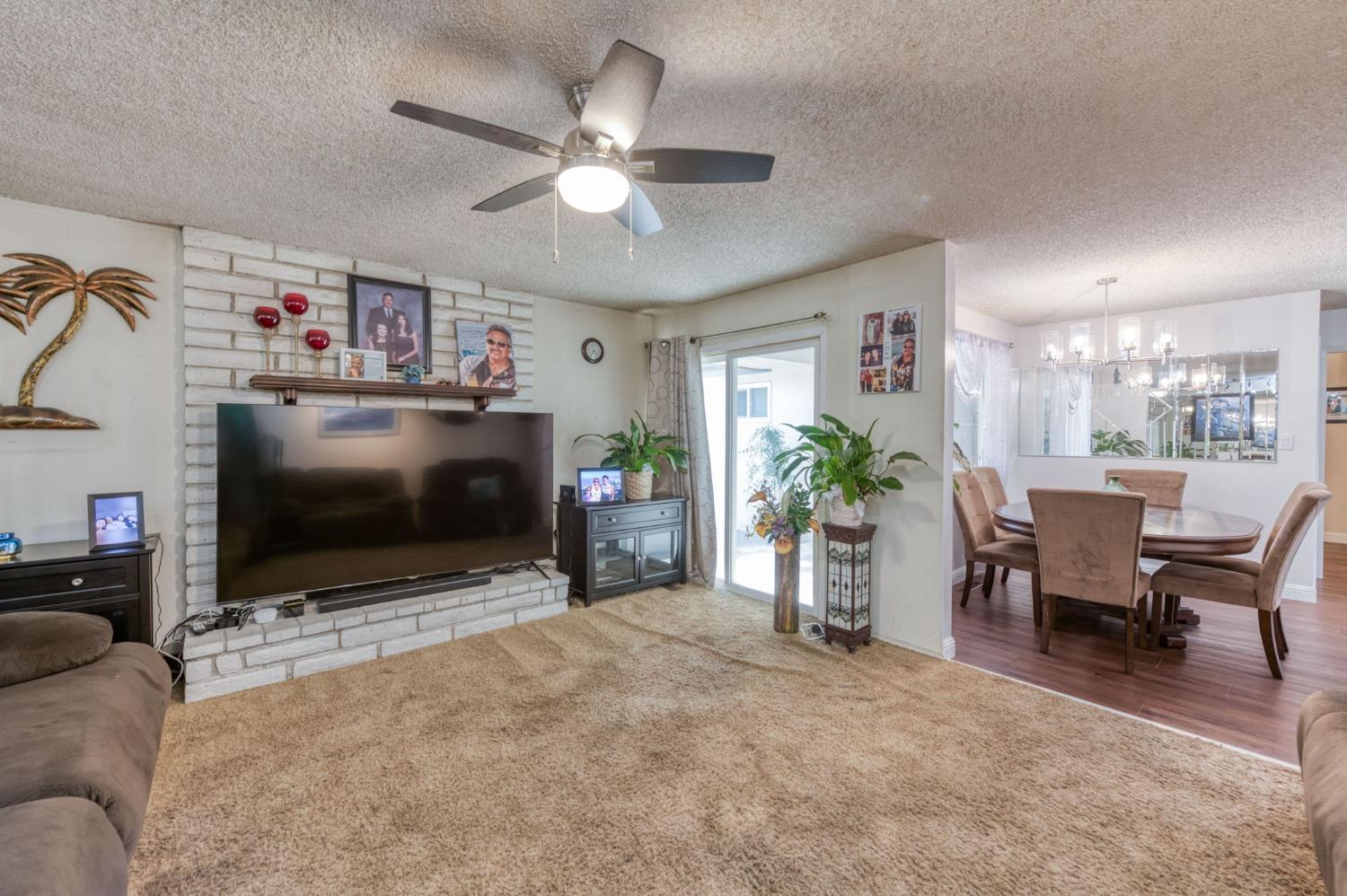 6811 North Backer Avenue Fresno, CA 93710 - Photo 13 of 26 a view of a livingroom with furniture and a flat screen tv
