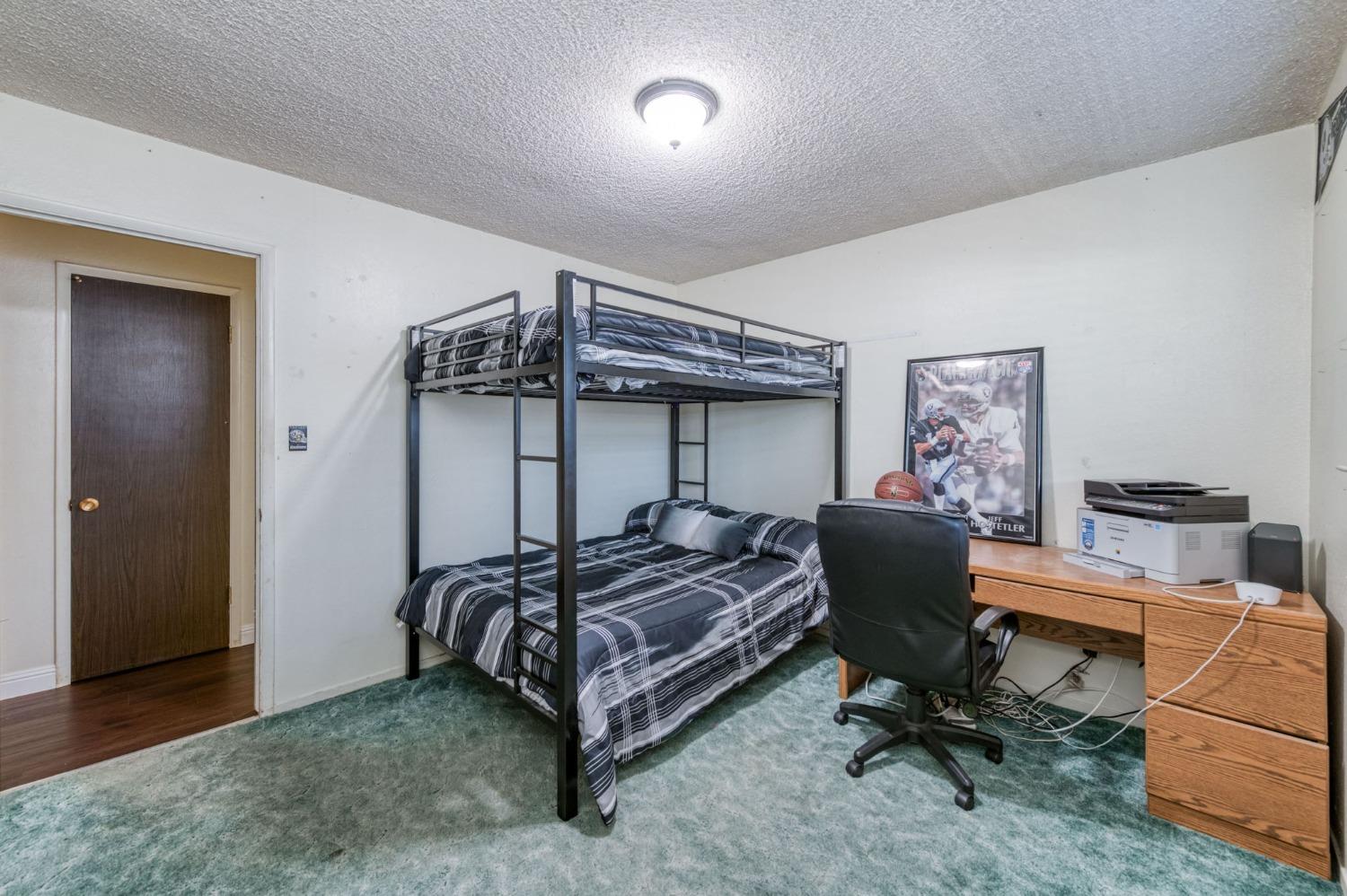 6811 North Backer Avenue Fresno, CA 93710 - Photo 17 of 26 a bedroom with bed and a furniture