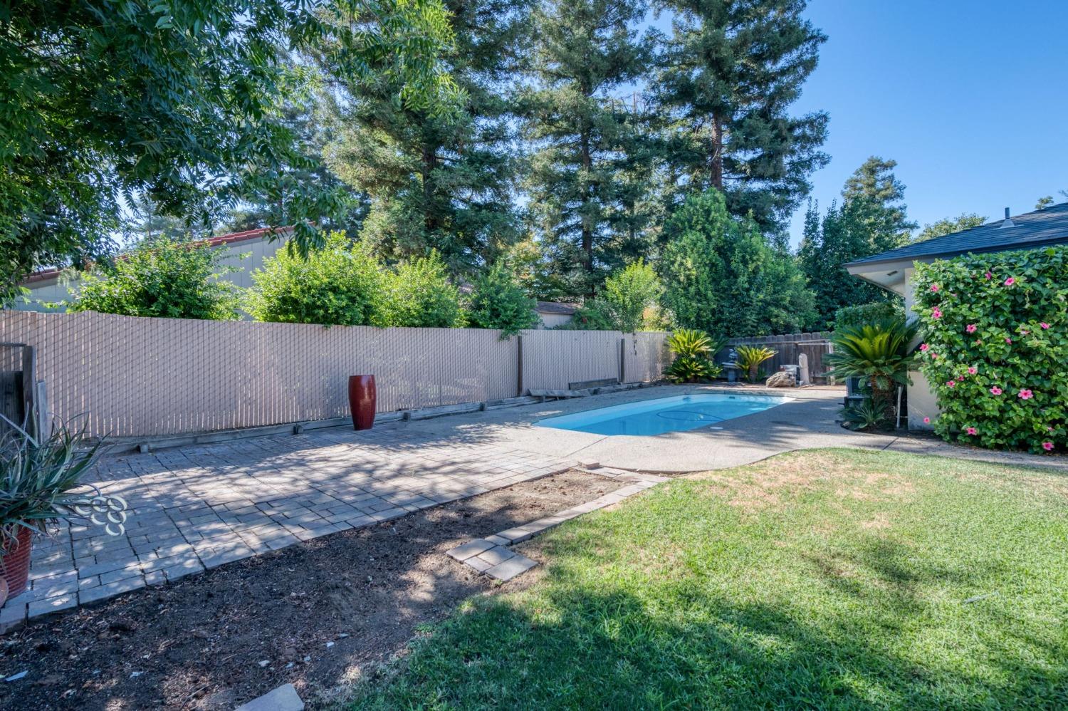 6811 North Backer Avenue Fresno, CA 93710 - Photo 23 of 26 a view of a backyard with large trees and plants