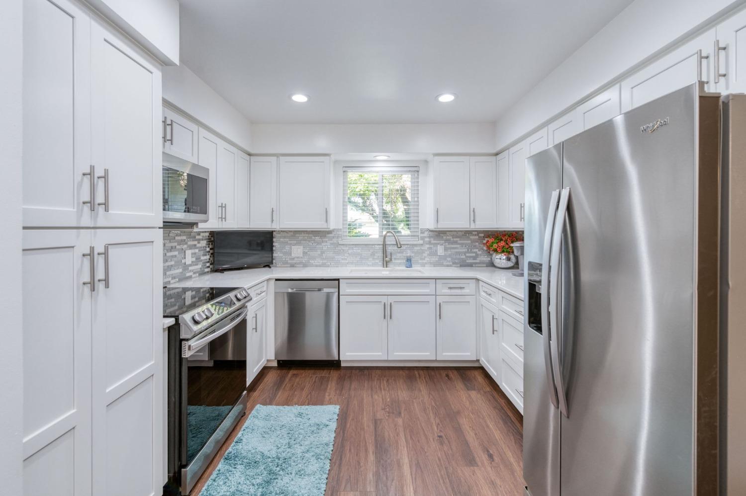 6811 North Backer Avenue Fresno, CA 93710 - Photo 7 of 26 a kitchen with a refrigerator stove and sink