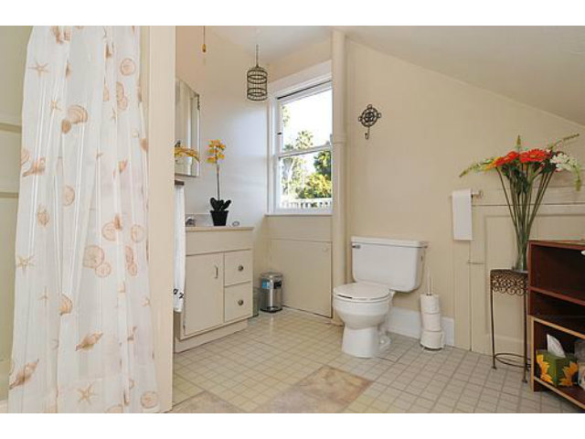 405 Middlefield Road Palo Alto, CA 94301 - Photo 10 of 11 a bathroom with a toilet sink and mirror