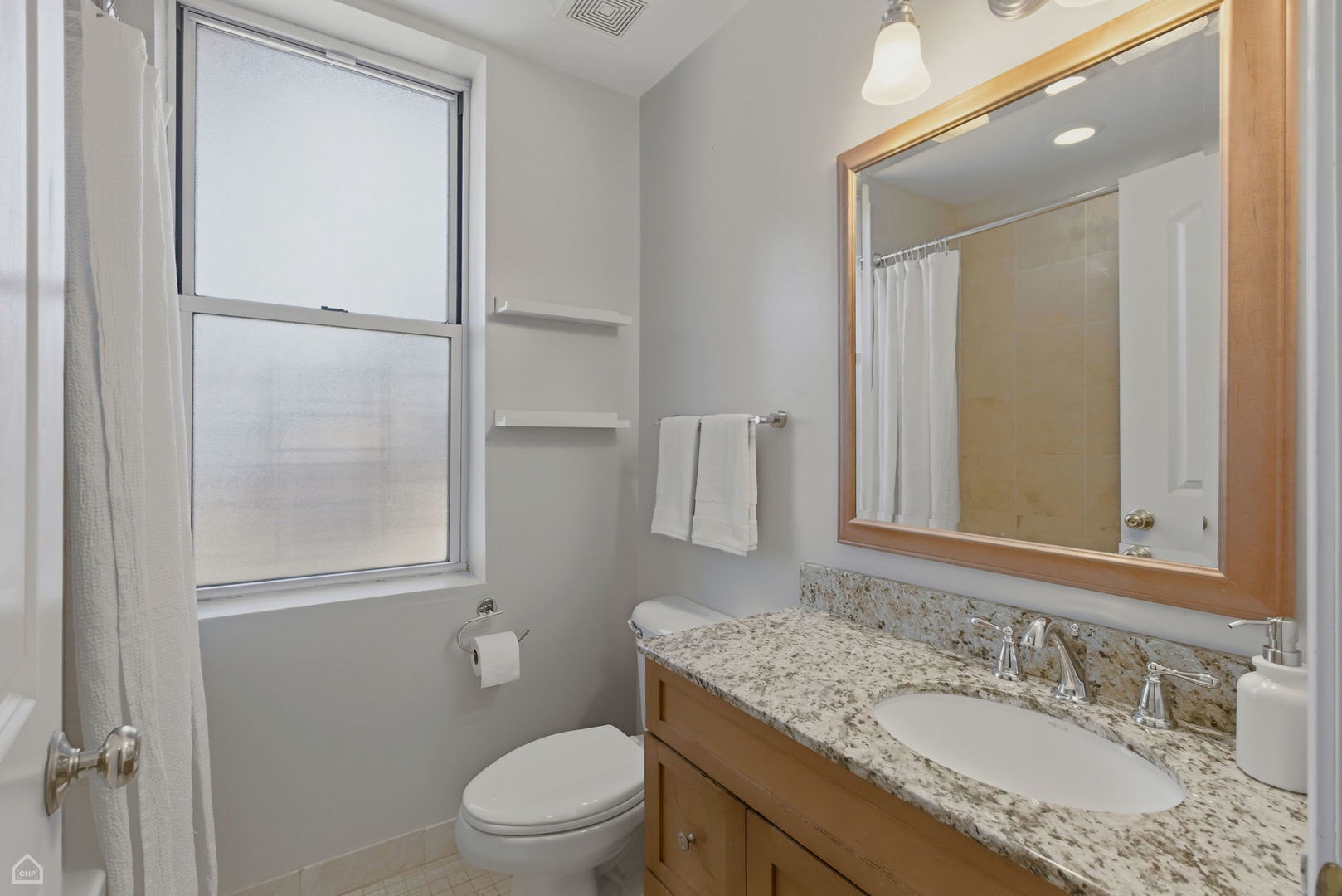 4444 North Beacon Street, Unit 1 Chicago, IL 60640 - Photo 12 of 18 a bathroom with a granite countertop sink toilet and shower