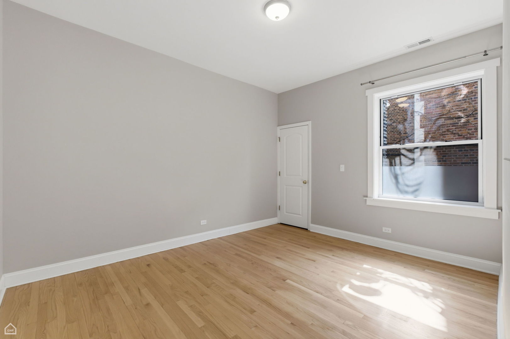 4444 North Beacon Street, Unit 1 Chicago, IL 60640 - Photo 13 of 18 wooden floor in an empty room with a window