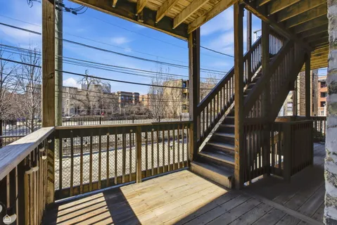 a view of staircase with a metal railing and a large window