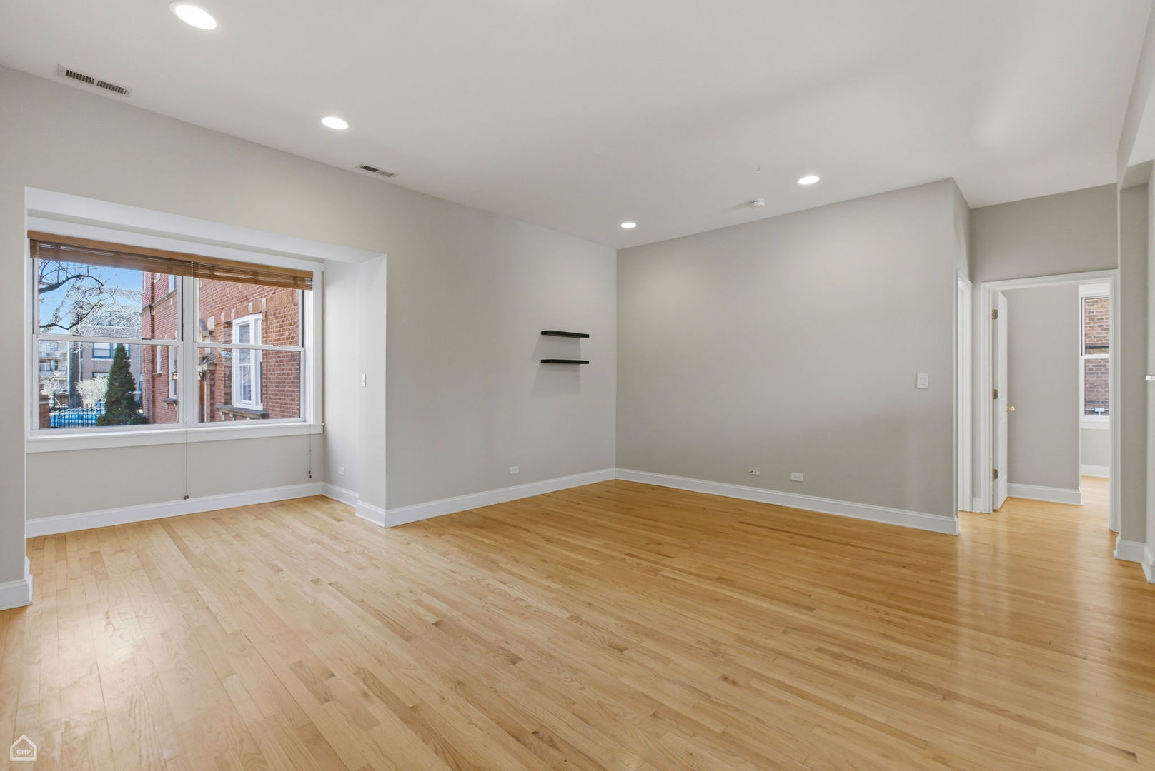 4444 North Beacon Street, Unit 1 Chicago, IL 60640 - Photo 2 of 18 a view of an empty room with wooden floor and a window