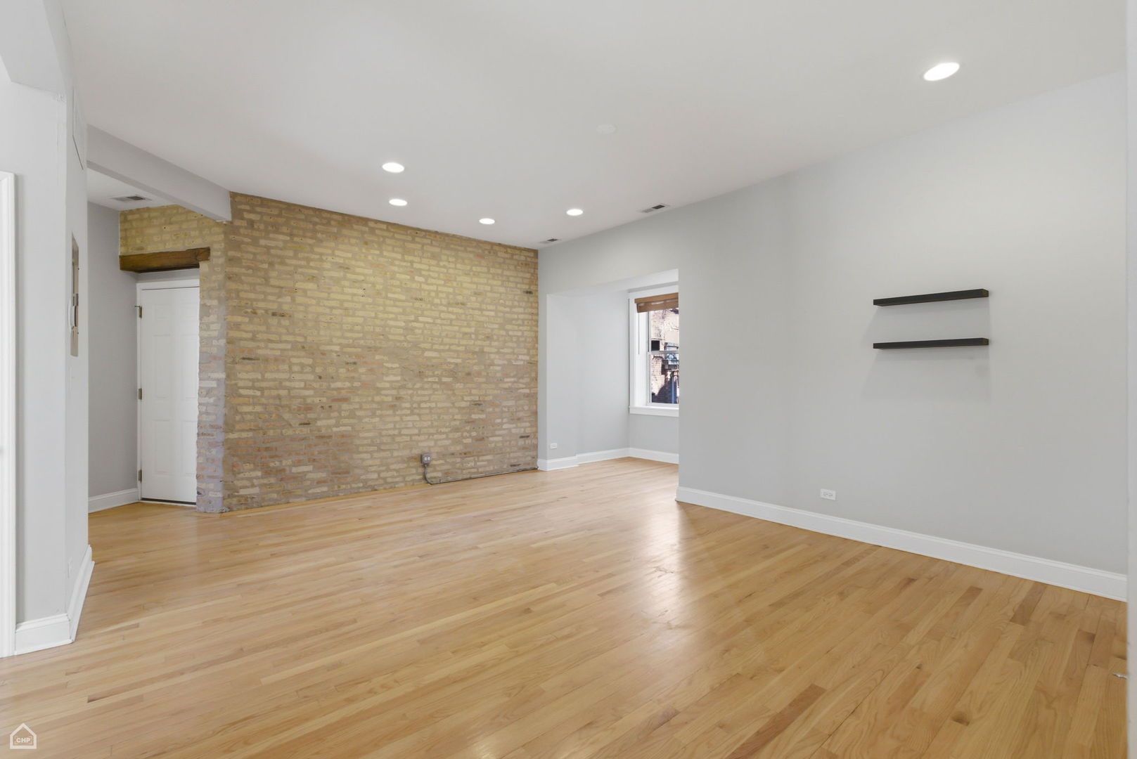 4444 North Beacon Street, Unit 1 Chicago, IL 60640 - Photo 3 of 18 wooden floor in an empty room with a window