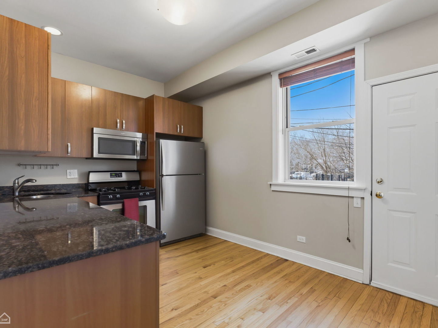 4444 North Beacon Street, Unit 1 Chicago, IL 60640 - Photo 7 of 18 a kitchen with stainless steel appliances granite countertop a refrigerator a stove top oven a sink and dishwasher