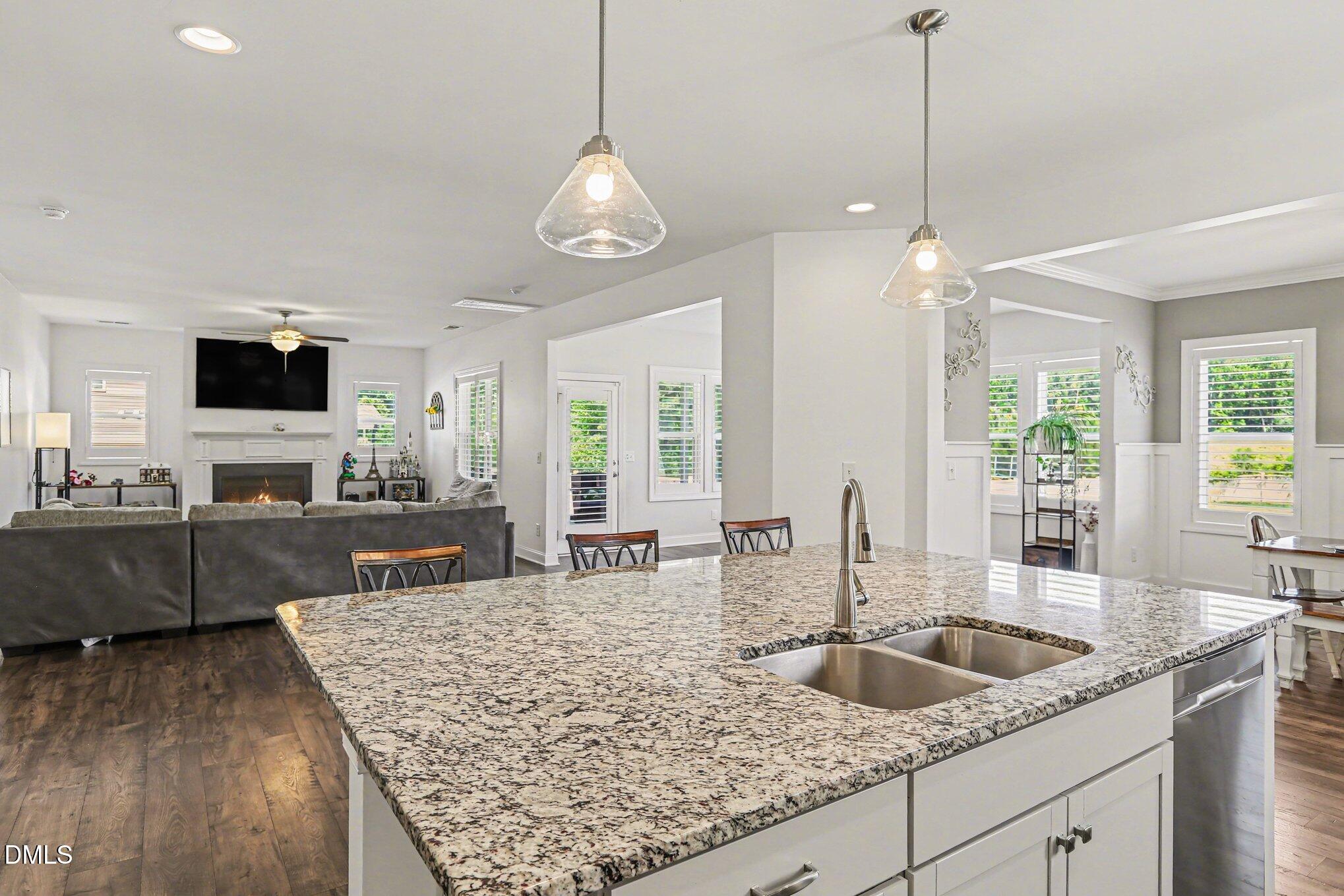 432 Seabring Lane Raleigh, NC 27603 - Photo 11 of 29 a kitchen with sink stove and wooden floor