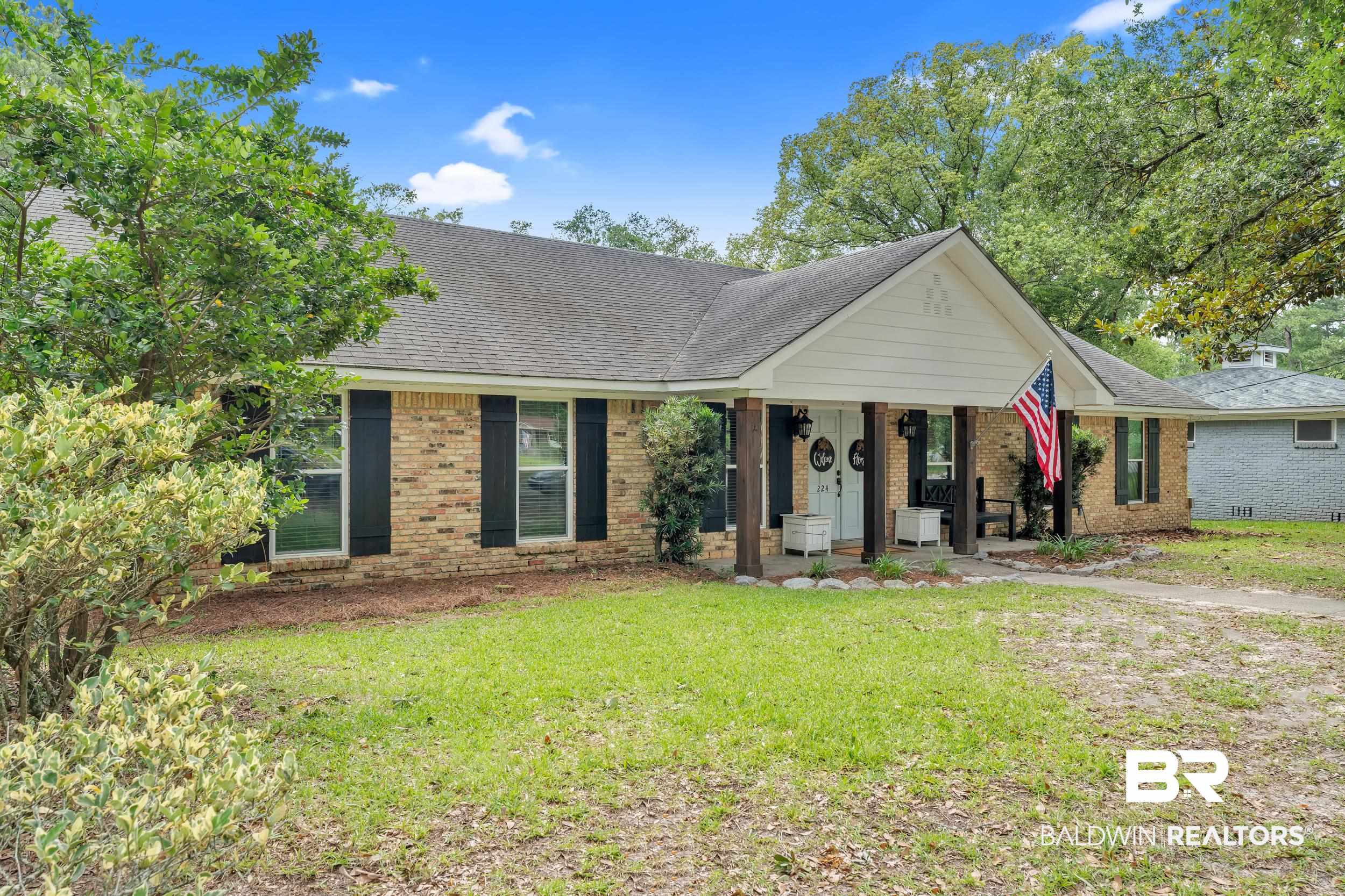 224 Cache Circle Mobile, AL 36611 - Photo 42 of 42 Ranch-style house featuring a front lawn, brick siding, a porch, and a shingled roof
