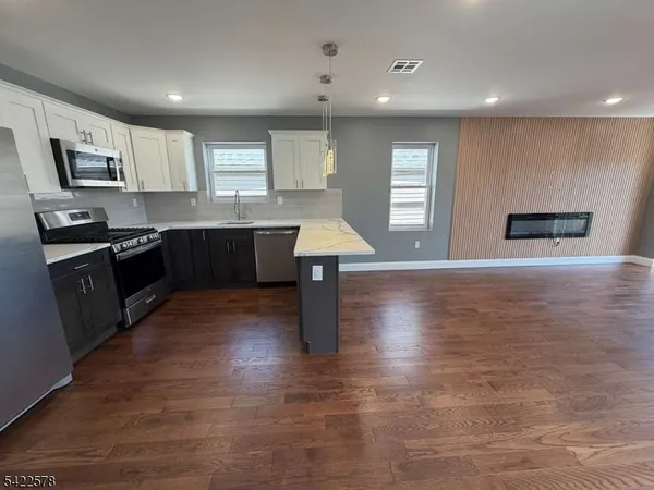 a kitchen with stainless steel appliances granite countertop a sink counter space and cabinets