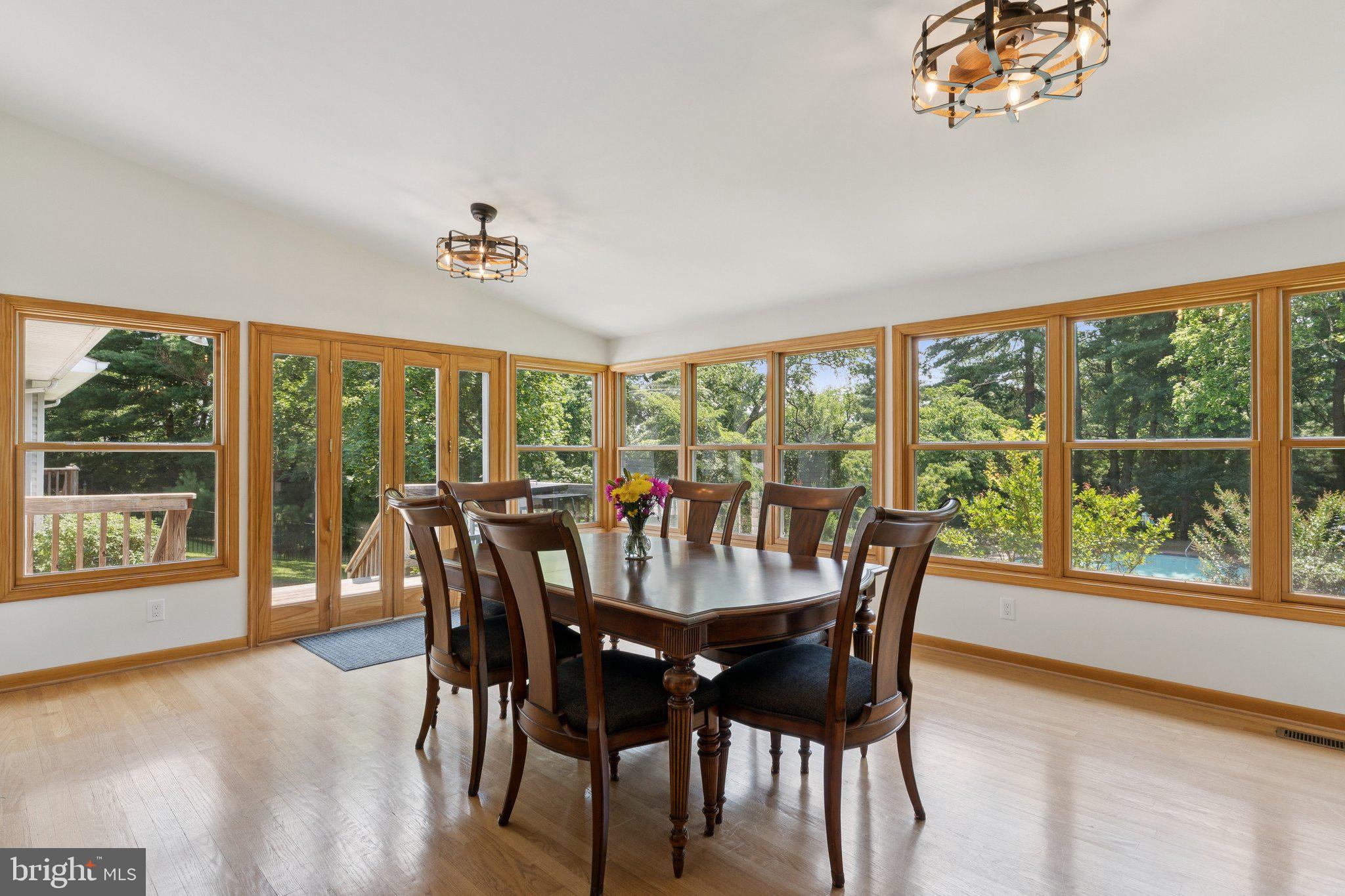 346 Edgewater Road Pasadena, MD 21122 - Photo 11 of 75 a view of a dining room with furniture large windows and wooden floor
