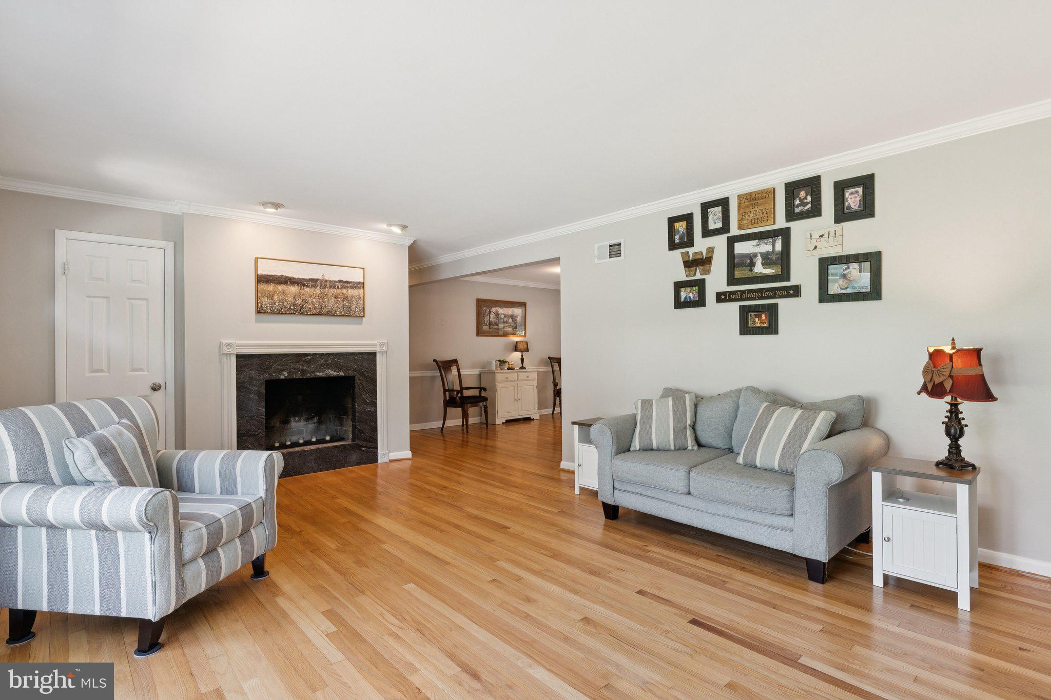 346 Edgewater Road Pasadena, MD 21122 - Photo 2 of 75 a living room with furniture and a fireplace