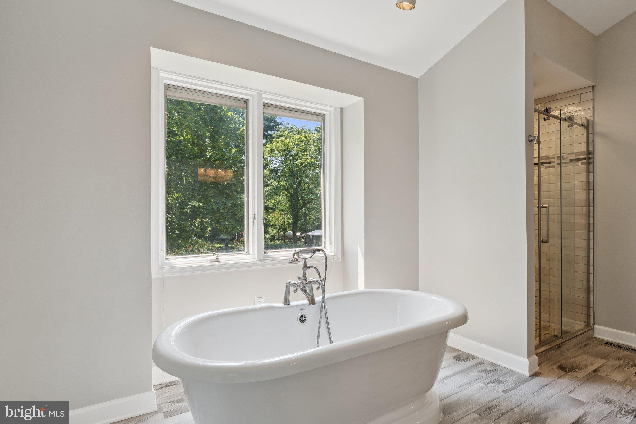346 Edgewater Road Pasadena, MD 21122 - Photo 27 of 75 a white bath tub sitting in a bathroom next to a window